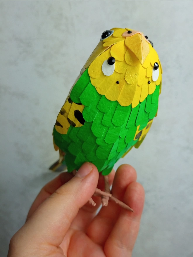 underbelly of a yellow and green budgie sculpture