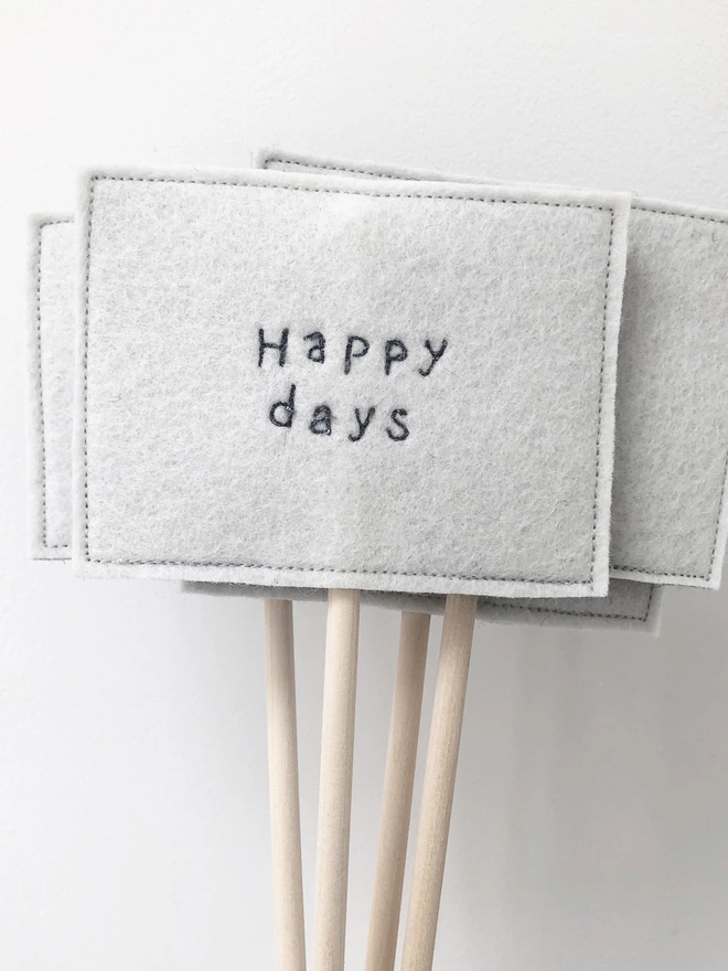 Group of happy days embroidered felt sign