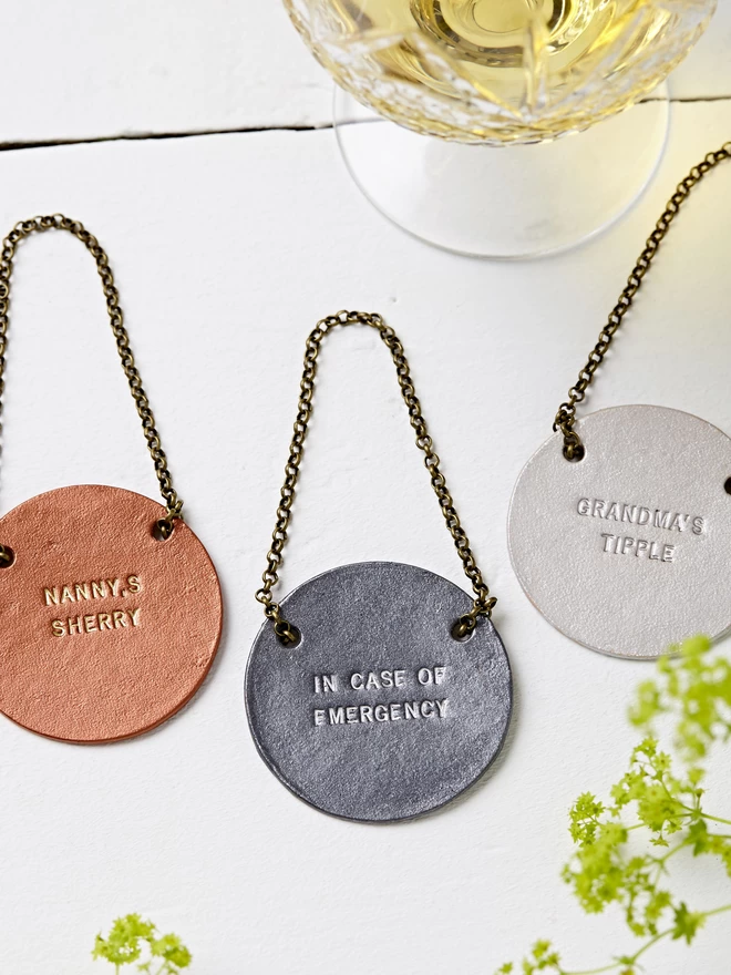 Copper, pewter and silver wine bottle tags