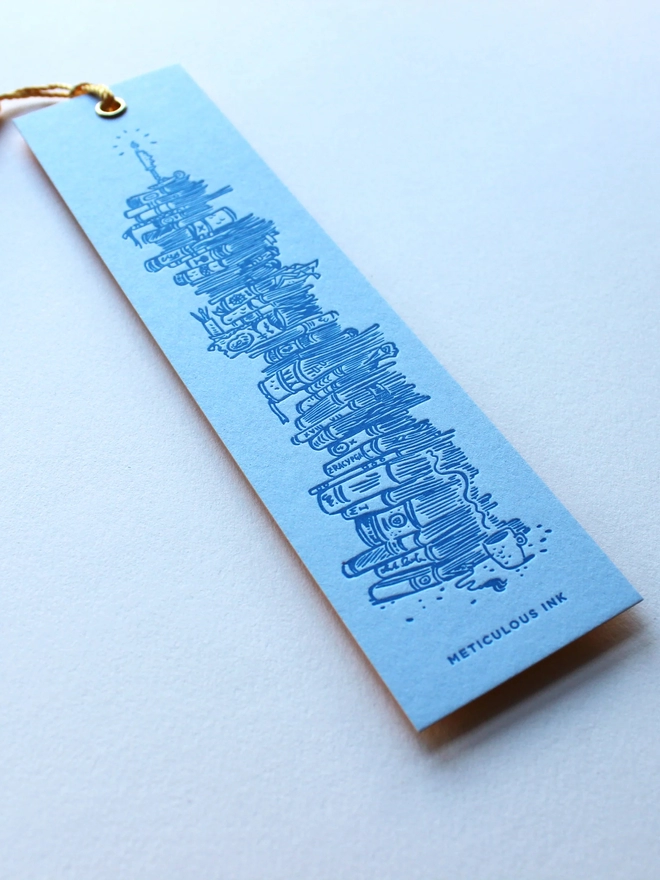 Stack of books letterpress bookmark close up