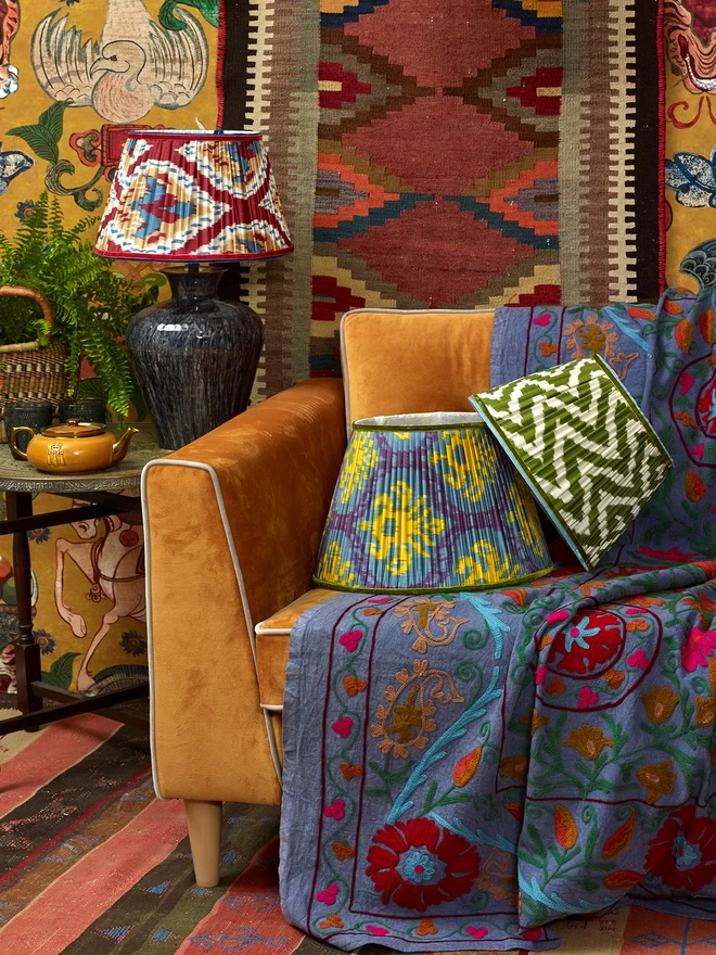 Maximalist Interior Design: Handmade Red-Blue Silk Ikat Lampshade in a Yellow-Styled Patterned Wallpapered Room