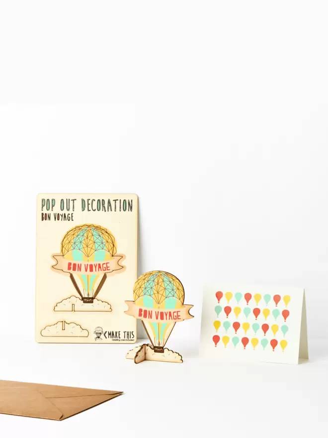 Bon voyage hot air balloon decoration and hot air balloon pattern card and brown kraft envelope on a white background