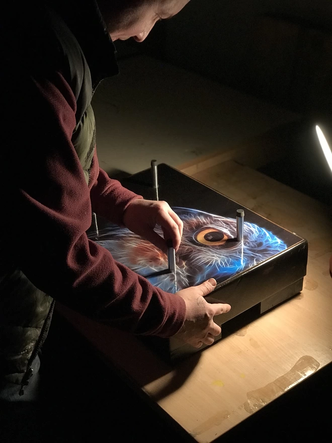 a man in workshop assembling a side table