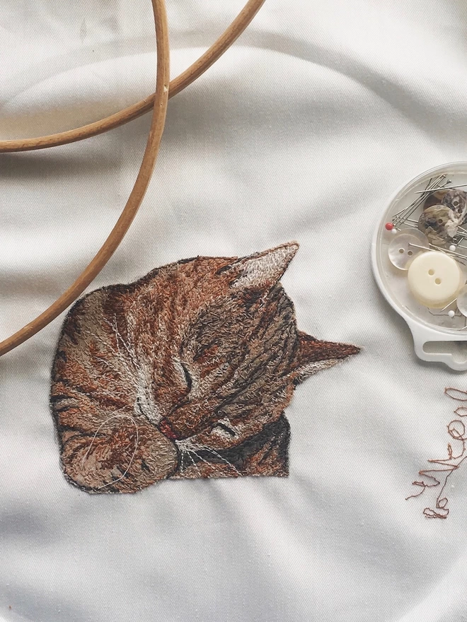 photo showing the making of a small embroidered pet portrait of a cat
