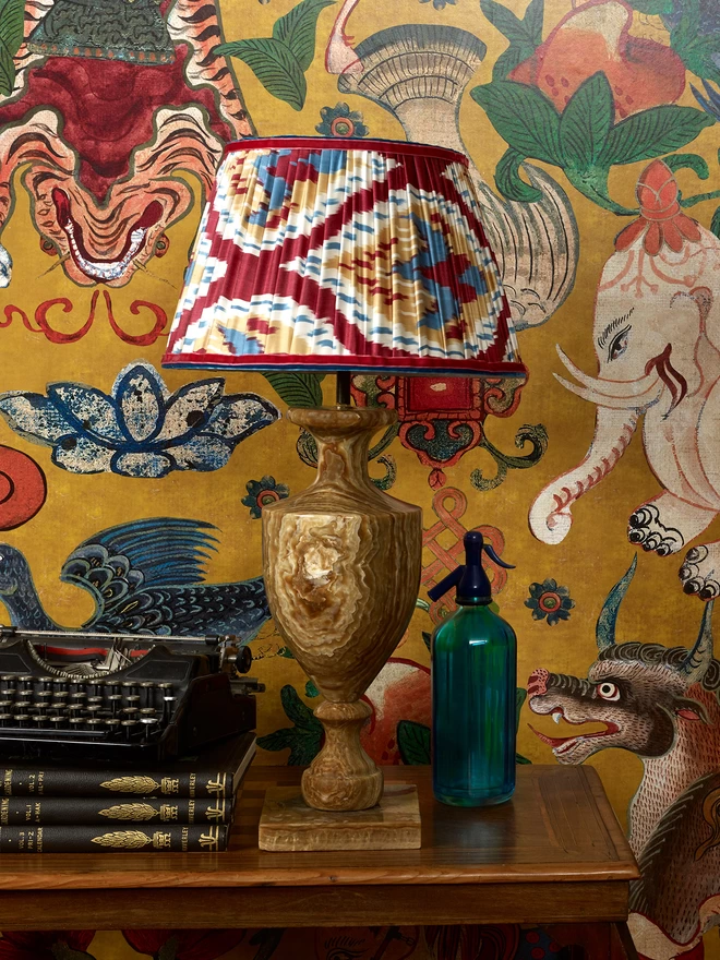 Handmade Red-Blue Silk Ikat Lampshade in a Yellow-Styled Patterned Wallpapered Room
