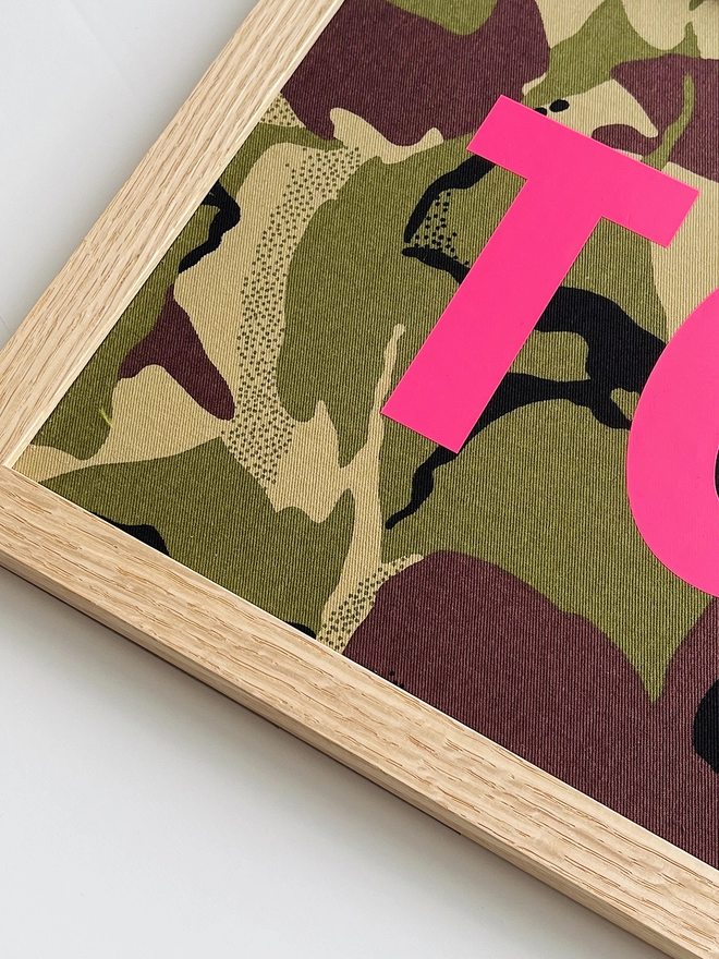 Personalised framed camouflage word/name picture close up of neon pink lettering