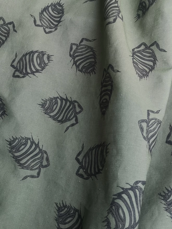 green Cotton Linen woven fabric with a charcoal woodlouse print