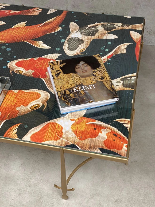 koi fish glass top on a gold metal frame