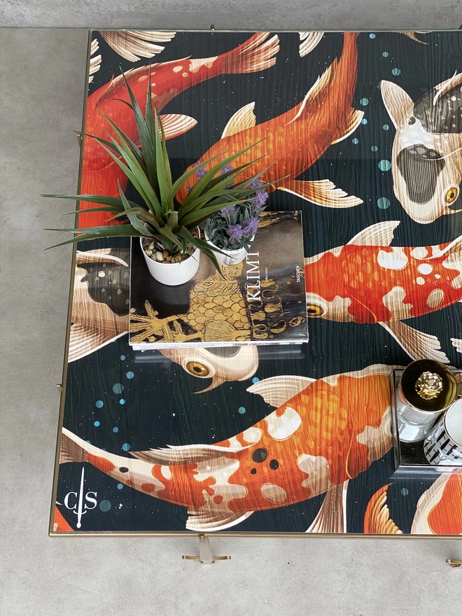 koi fish design on glass top coffee table