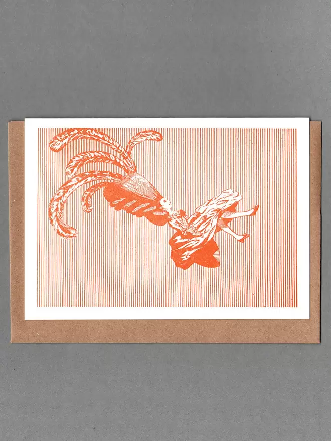 White card with an orange illustration of a Victorian lady, with a brown envelope behind.