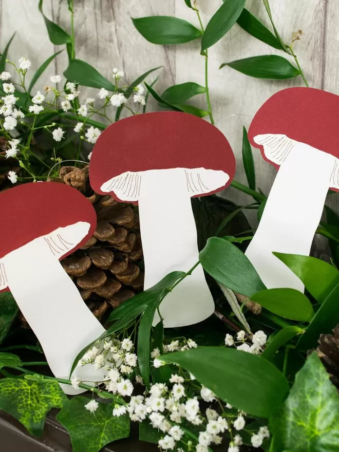 Mushroom Paper Decorations displayed amongst greenery