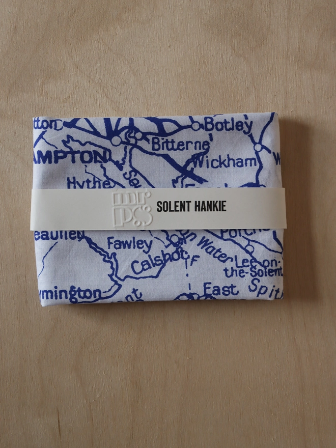 A folded Mr.PS Solent map hankie printed in blue