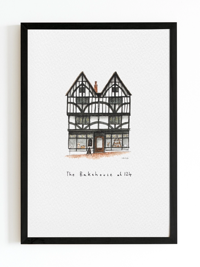 Beautiful watercolour illustration of The Bakehouse at 124, bakery in Tonbridge.  A characterful black and white tudor style three storey building with large windows on the ground floor allowing a glimpse into the bakery. The watercolour style is painted with a black pen outline and organic loose style with small details.  The print is on white background with black frame around.
