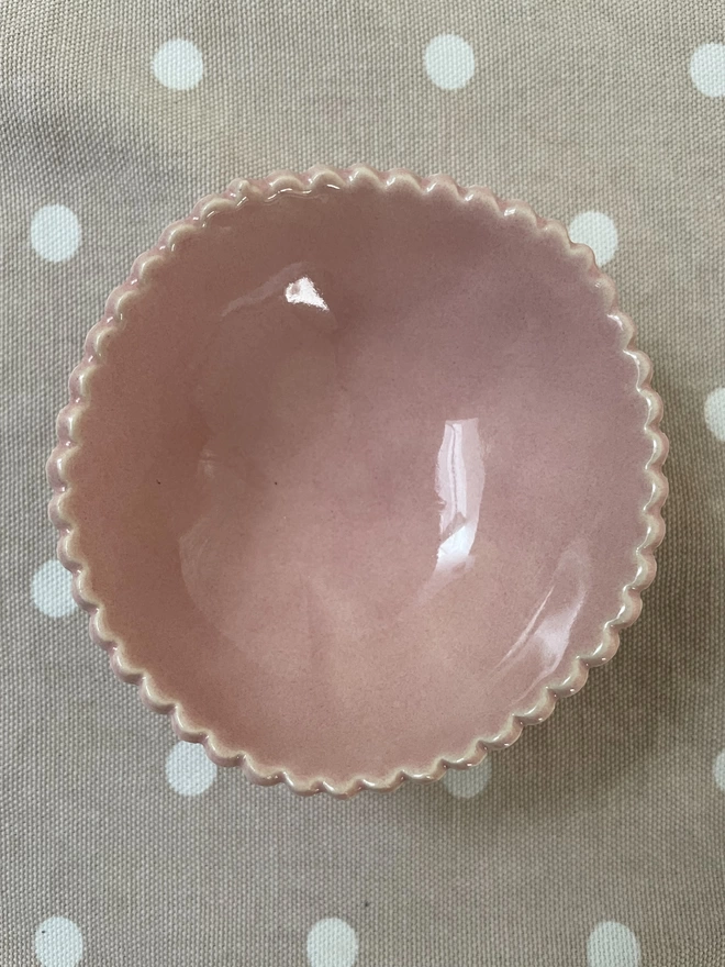 small pink handmade ceramic pottery bowl with scalloped edge