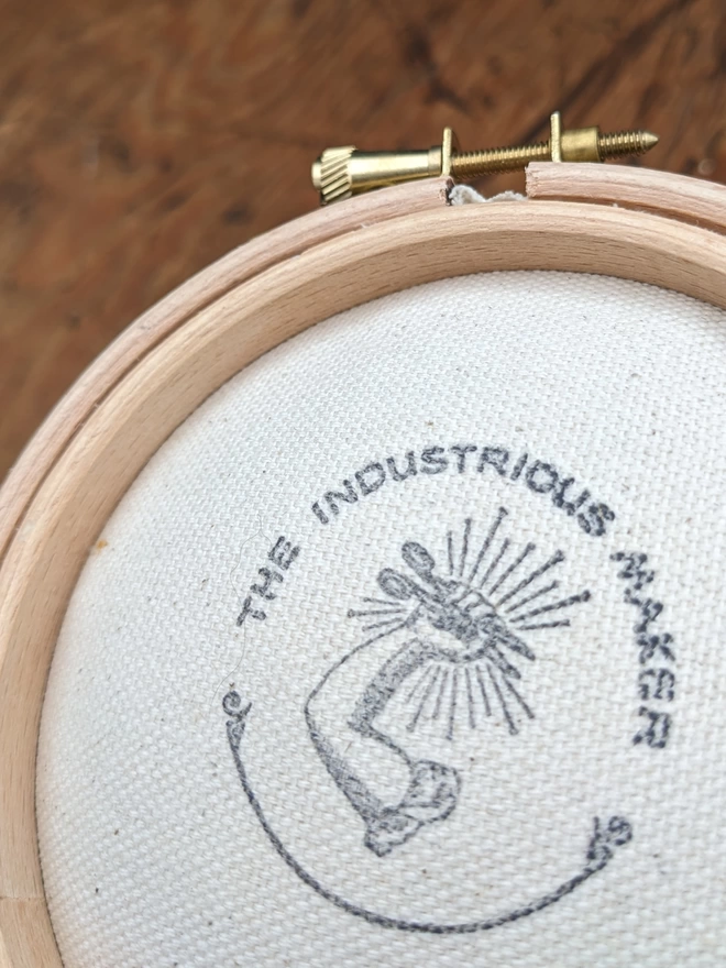 close up of back of embroidery hoop pin cushion with Industrious Maker logo