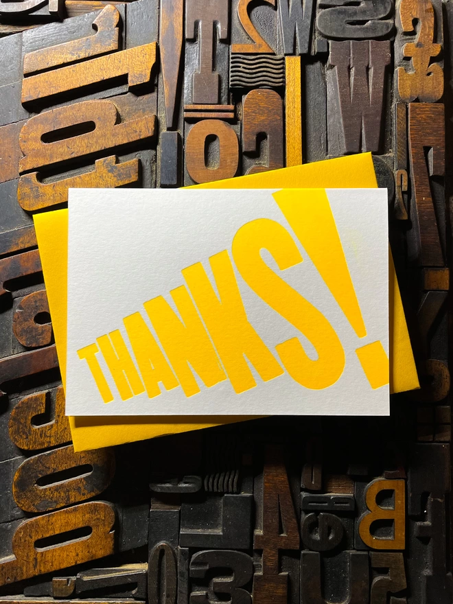 Thanks! A vibrant thank you typographic letterpress card with deep impression print using fluorescent yellow, with a range of colourful envelopes. Slight print variations adding to the style anding to the charm of this handmade greeting card.