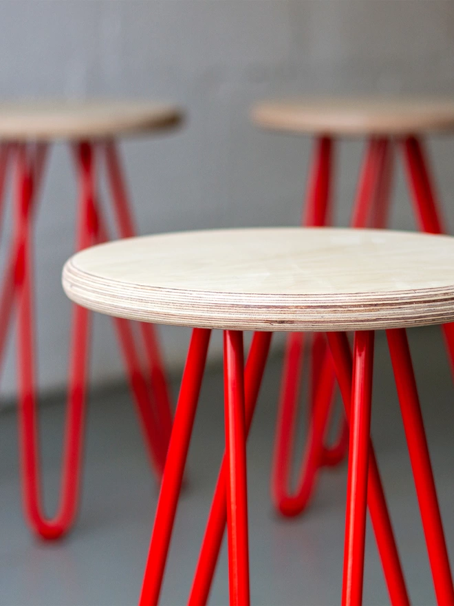 hairpin leg stool with plywood seat and red legs