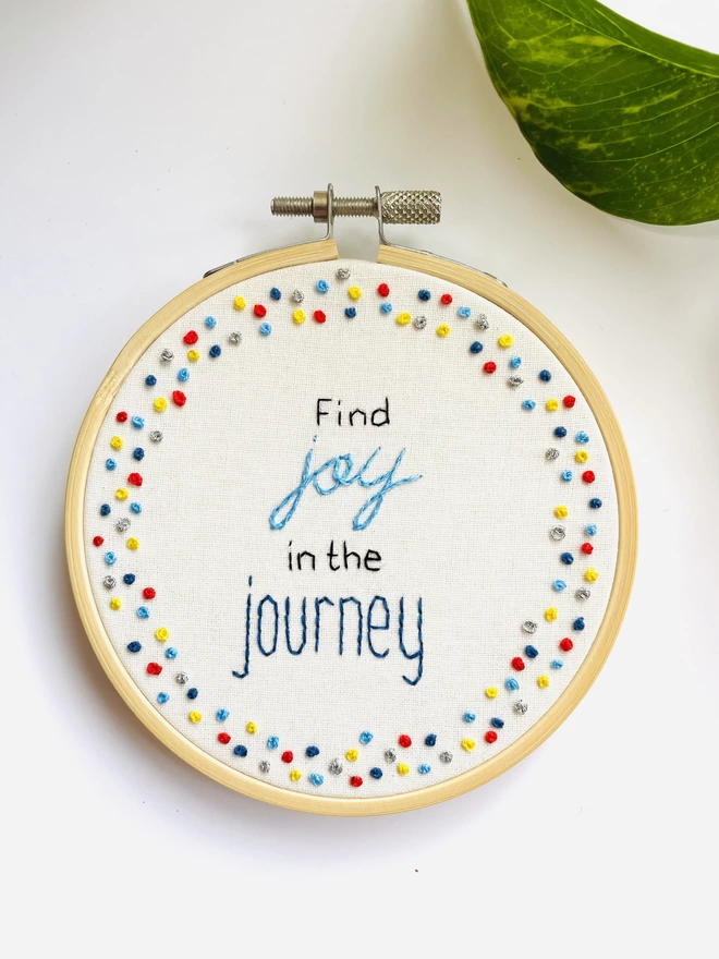 Hand embroidered hoop art reads find joy in the journey surrounded by colourful french knot border