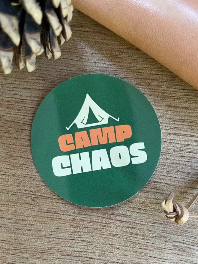 Camp Chaos Vinyl Sticker on a wooden table.