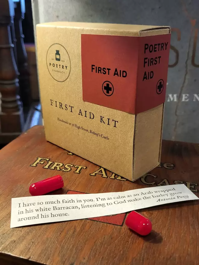 First Aid Kit with empty pill capsule and poetic extract printed on banana paper