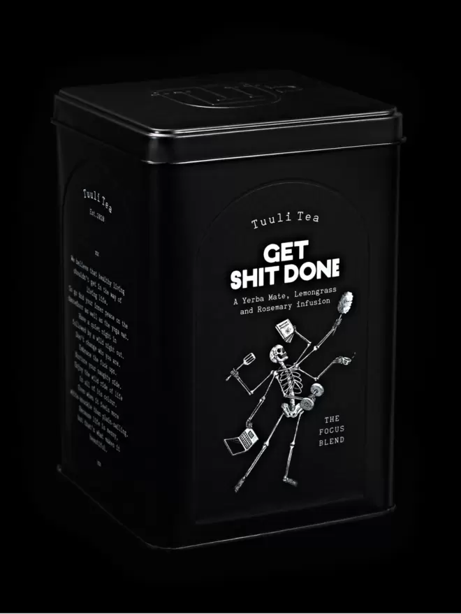 A black tin of Get Shit Done herbal tea photographed on a black background. 