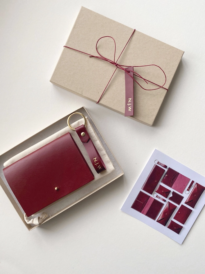 Burgundy wallet with keyring in Kraft gift box, with matching leather gift tag and flyer