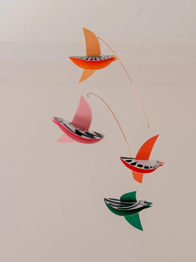 Four colourful birds in a hanging mobile 