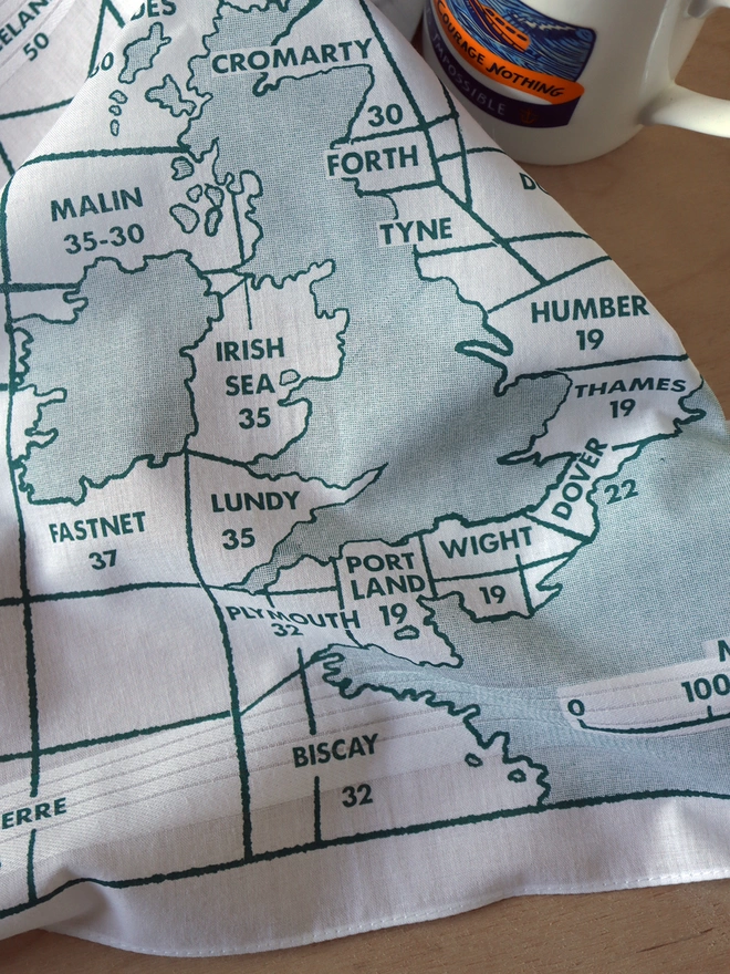 Detail of a Mr.PS Shipping forecast map hankie with an RNLI mug