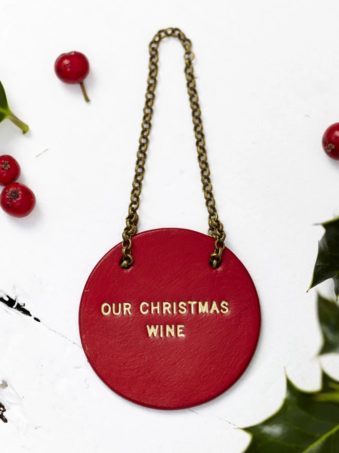 red Christmas bottle tag, with our Christmas wine stamped in gold font.