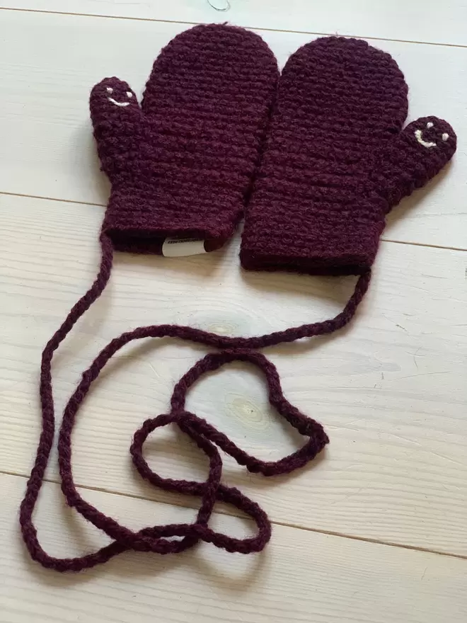 Plum smiley face mittens