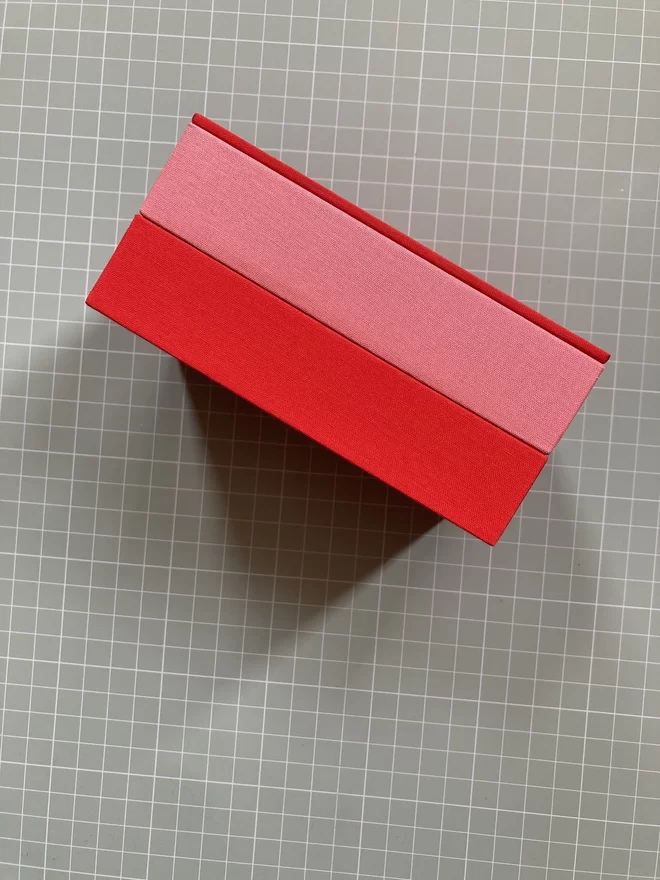 Small version of the stacking jewellery keepsake box in geranium red and japonica pink book cloth
