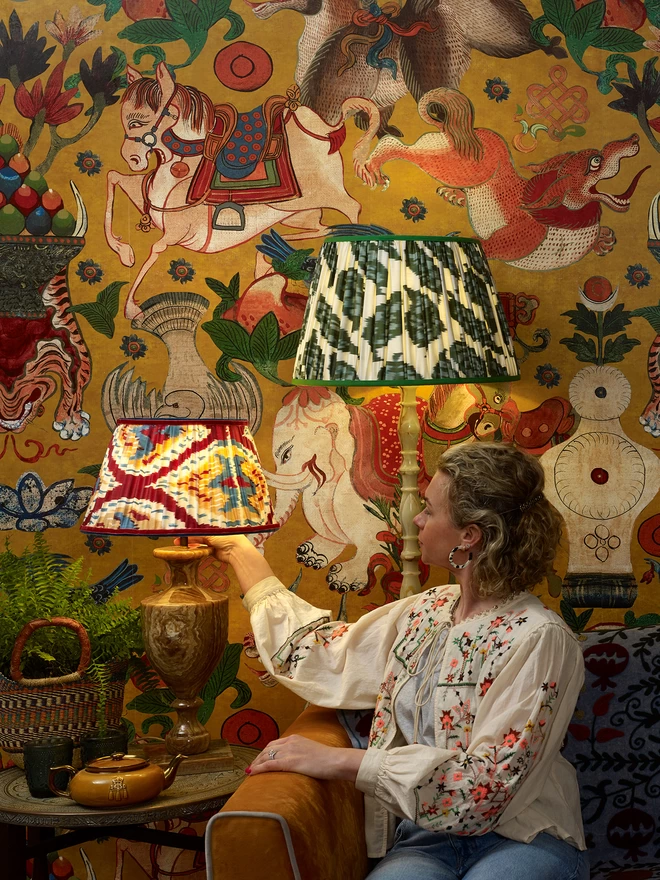Two Handmade Silk Ikat Lampshades in a Yellow-Styled Patterned Wallpapered Room