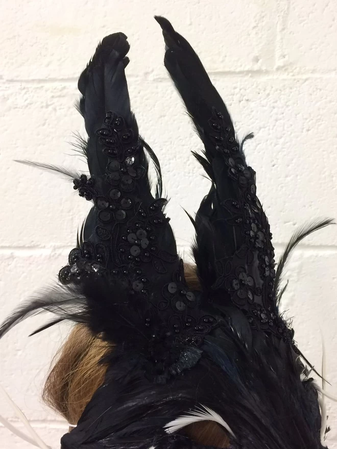 Detail of lace, bead and sequin embellishment on luxury black rabbit party mask ears