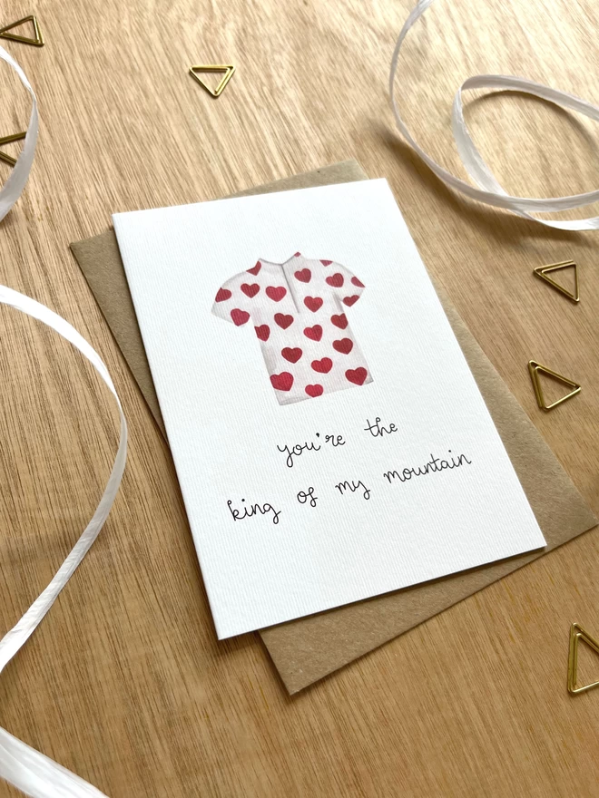 a greetings card with a polka dot king of the mountains cycling jersey where the spots are hearts and the text “you’re the king of my mountain”