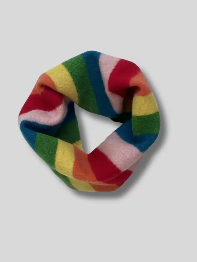 Rainbow stripe knitted snood shown from above on a white background