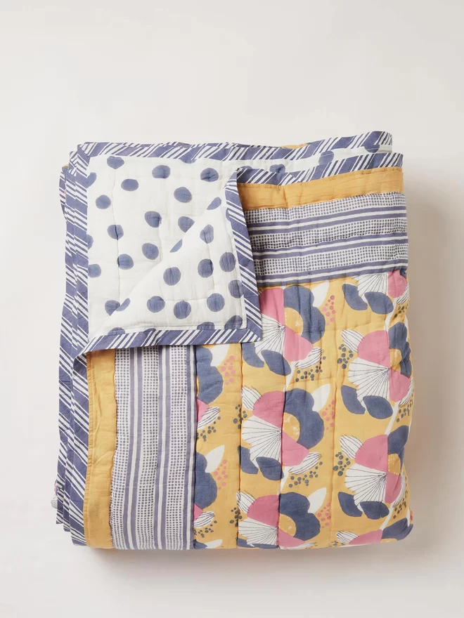Reversible block printed yellow floral and spotty quilt