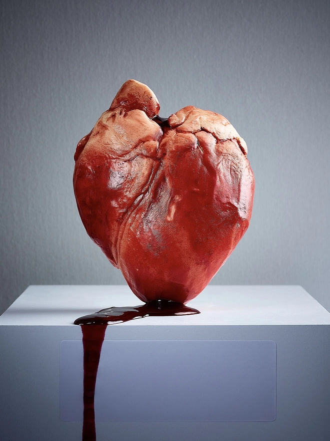 Realistic ebible chocolate human heart dripping