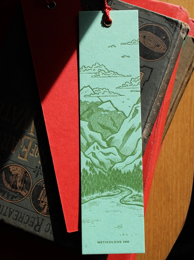 Landscape letterpress bookmark top view on stack of books