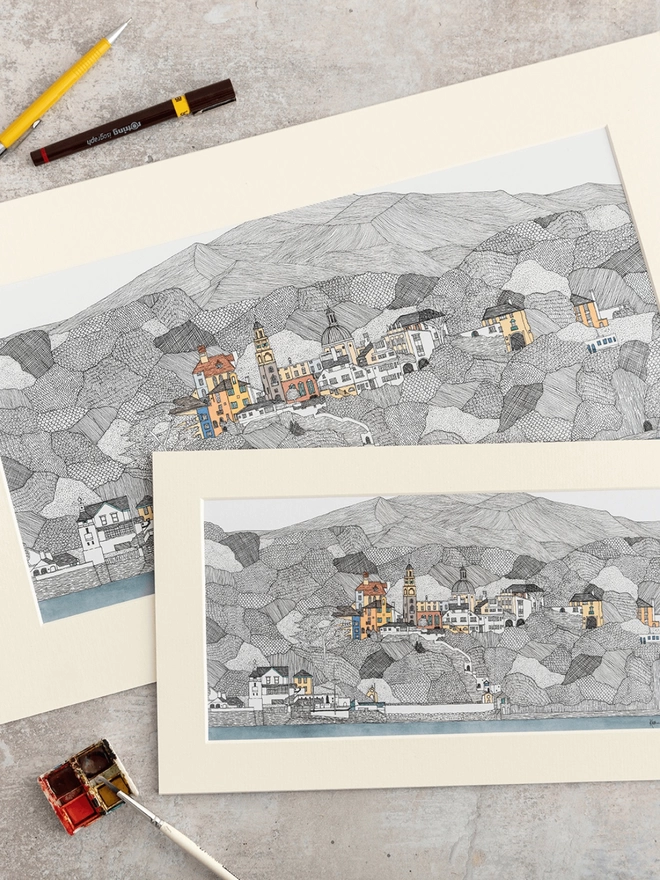 Prints of detailed pen and watercolour drawings of Portmeirion and welsh hills, in a soft white mount