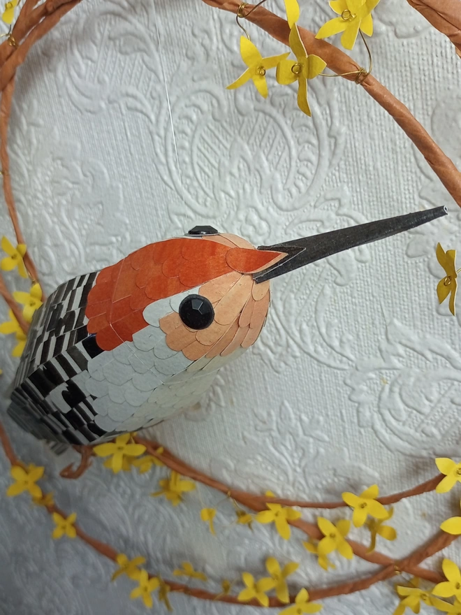 close up of a paper sculpture of a woodpecker