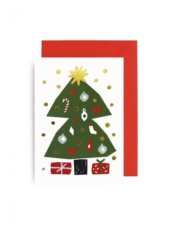 Greeting card with an image of a christmas tree with ornaments on it, presents sat underneath, and gold snow all around