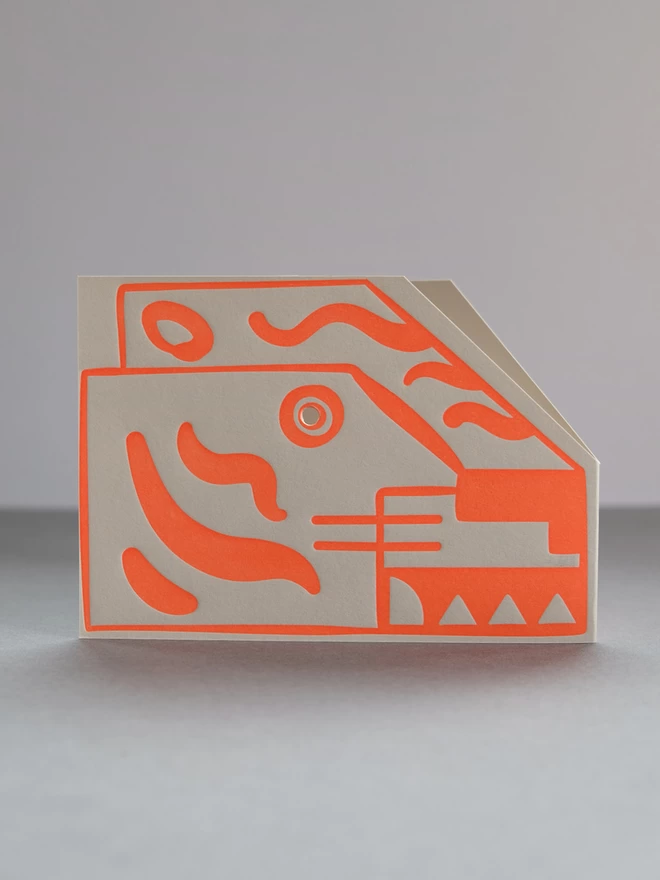 Side view of Tiger head card printed with bright orange ink.