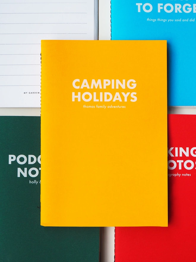 a notebook with personalised text saying camping holidays