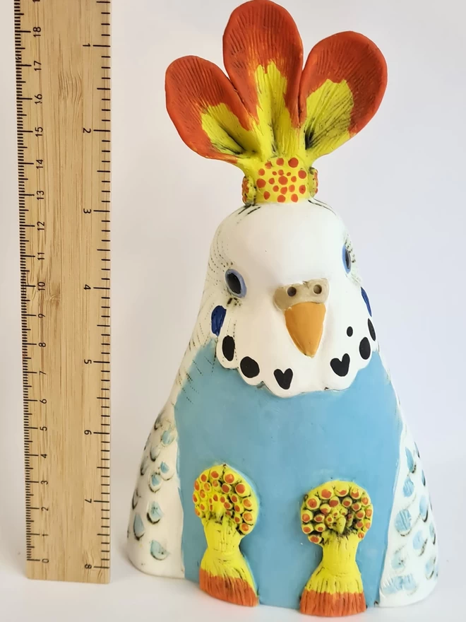 Charlotte Miller handmade ceramic sculpture of Lola the Showgirl seen with a ruler for scale.
