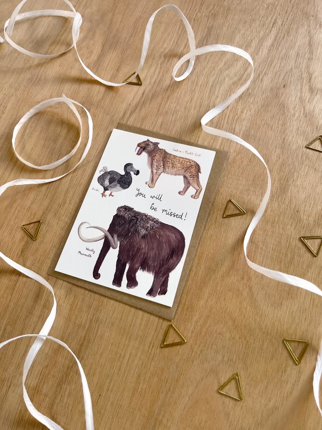 a greetings card featuring a dodo, a sabre tooth tiger and a woolly mammoth with the phrase “you will be missed”