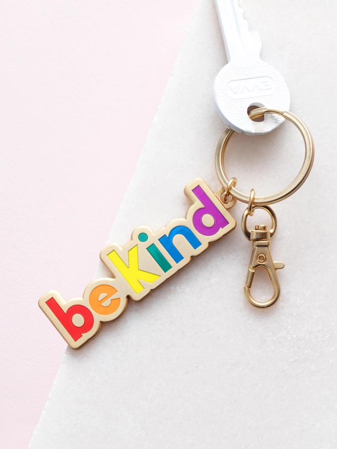 Enamel keyring with 'Be Kind' design in rainbow colours