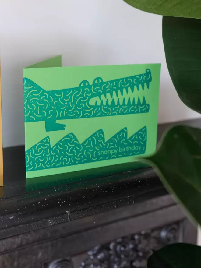 Crocodile illustrated card, letterpress printed, green ink on green card.