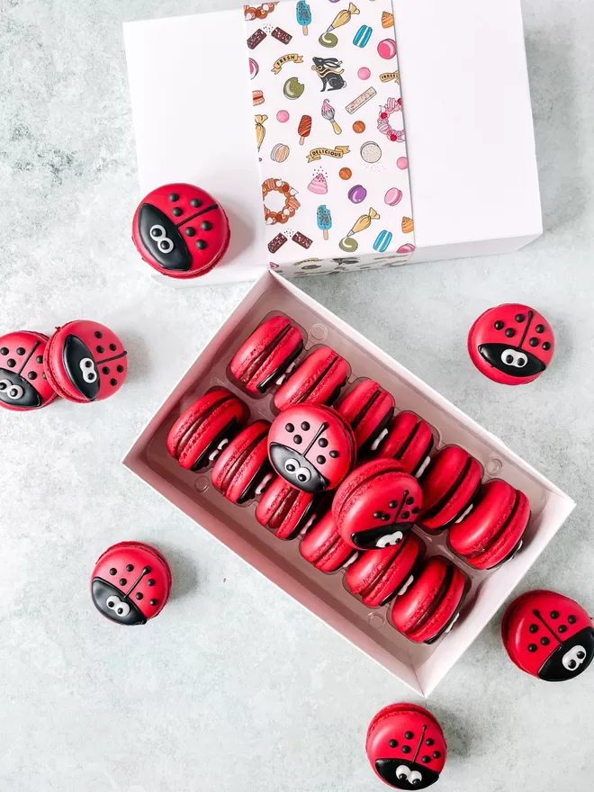 red ladybug macarons in a white gift box