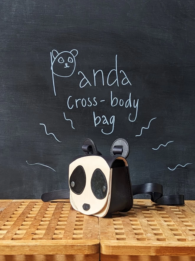 Handmade leather Panda cross- body bag, viewed from the side