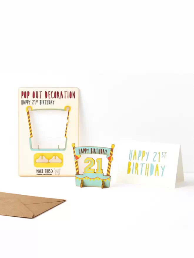 Twenty first birthday decoration and twenty first birthday card and brown kraft envelope on a white background